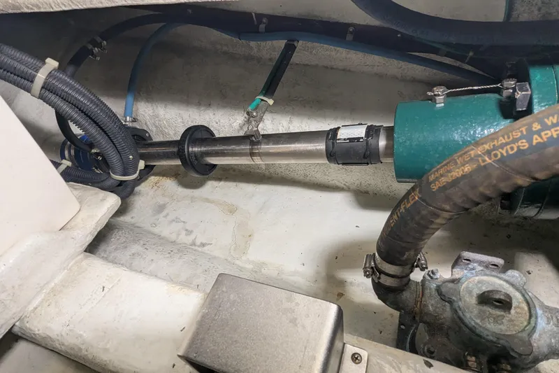 Slide: The Image of Engine room of 2005 Kadey-Krogen Pilothouse showing mechanical components and hoses. - 159