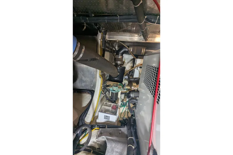 Slide: The Image of Engine room of a 2005 Kadey-Krogen Pilothouse with visible pipes and machinery. - 161