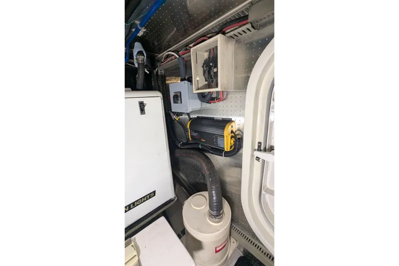 Slide: The Image of Engine room of 2005 Kadey-Krogen Pilothouse with electrical components and equipment. - 165