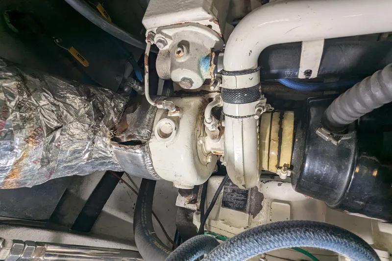 Slide: The Image of Engine room of 2005 Kadey-Krogen Pilothouse showing mechanical components and piping. - 168