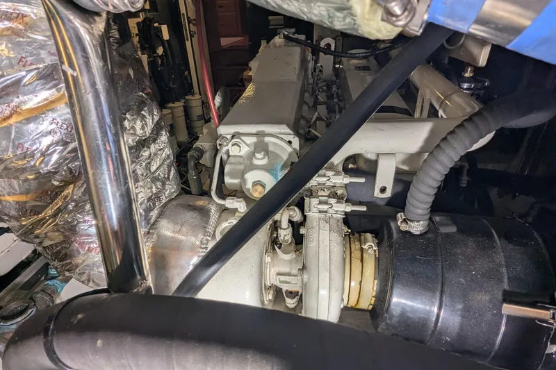 Slide: The Image of Engine room of a 2005 Kadey-Krogen Pilothouse, showcasing mechanical components and insulation. - 169