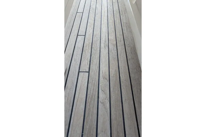 Slide: The Image of Teak deck of 2005 Kadey-Krogen Pilothouse yacht, featuring sleek, parallel lines. - 18