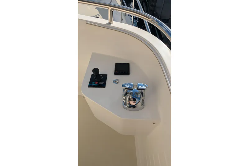 Slide: The Image of 2005 Kadey-Krogen Pilothouse boat controls with joystick and chrome fittings. - 23