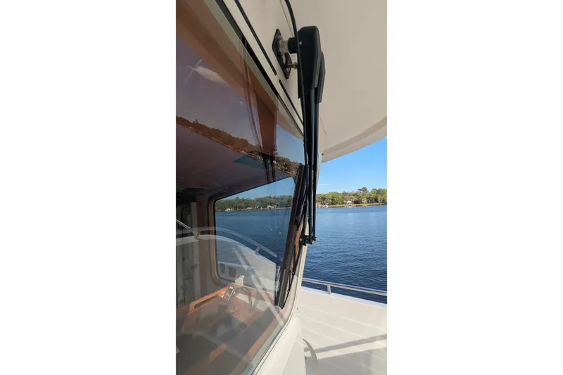 Slide: The Image of 2005 Kadey-Krogen Pilothouse boat window view with scenic waterfront background. - 26