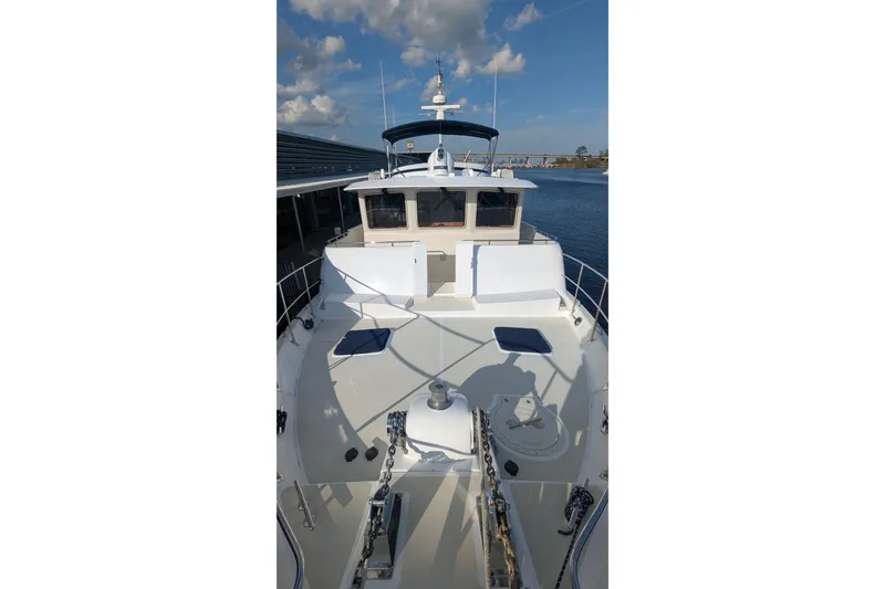 Slide: The Image of 2005 Kadey-Krogen Pilothouse yacht deck with clear sky and water view. - 3
