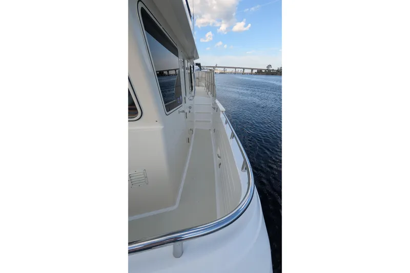 Slide: The Image of 2005 Kadey-Krogen Pilothouse yacht deck view with ocean and bridge in background. - 32