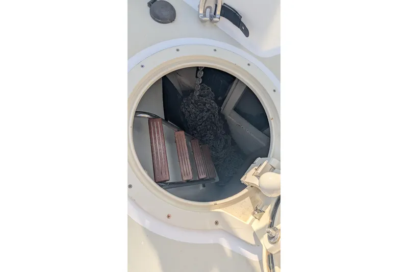 Slide: The Image of Hatch opening on 2005 Kadey-Krogen Pilothouse, revealing interior with steps and chain. - 36