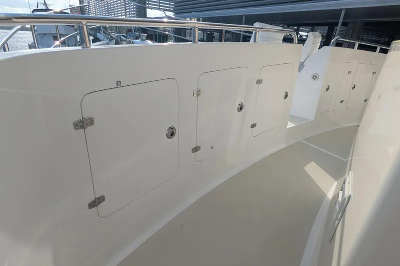 Slide: The Image of 2005 Kadey-Krogen Pilothouse yacht deck with storage compartments and stainless steel railings. - 37