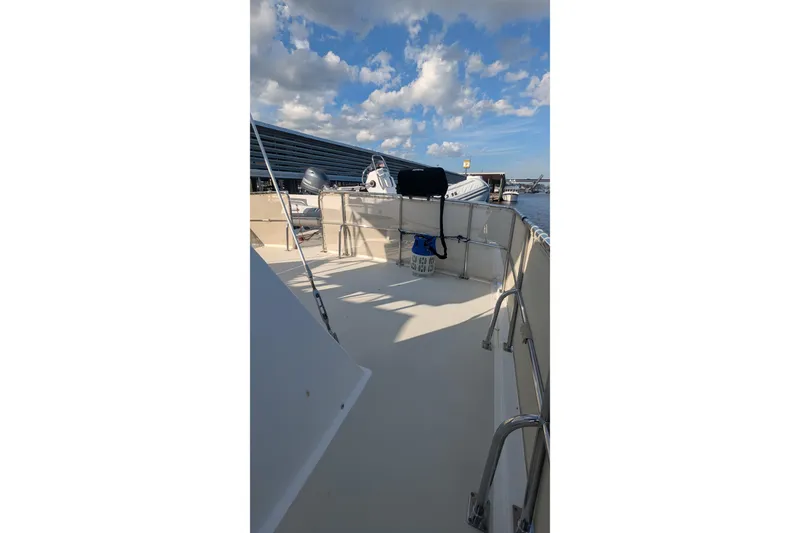 Slide: The Image of 2005 Kadey-Krogen Pilothouse deck with clear sky and marina view. - 39