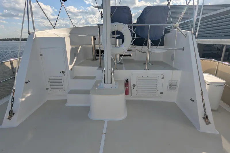 Slide: The Image of 2005 Kadey-Krogen Pilothouse deck with seating, life preserver, and ocean view. - 42