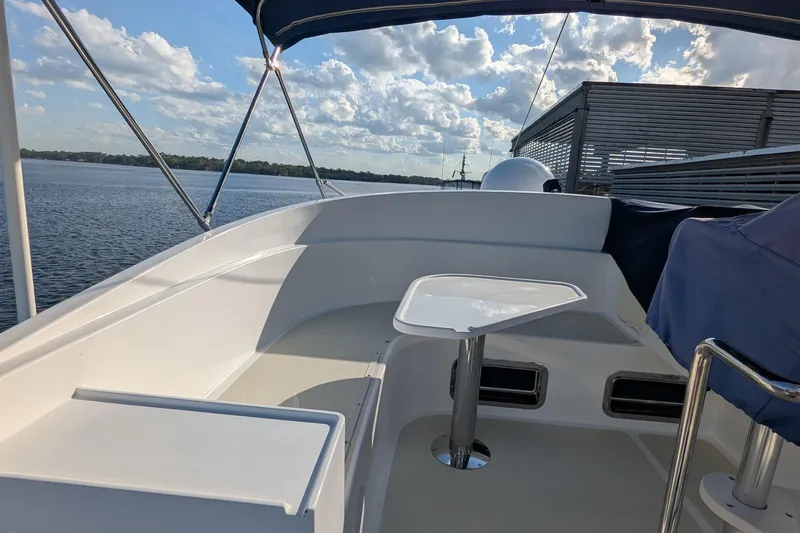 Slide: The Image of 2005 Kadey-Krogen Pilothouse boat deck with table, overlooking serene water and sky. - 45