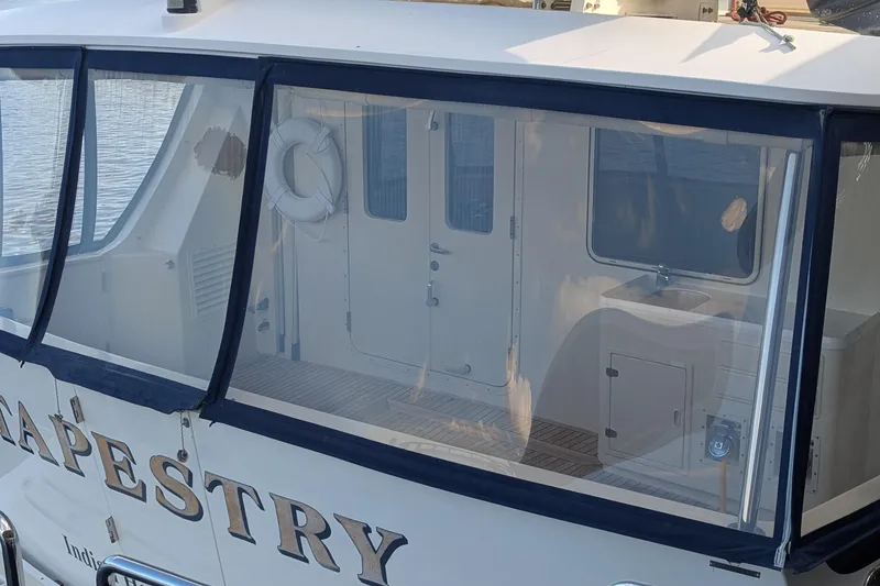 Slide: The Image of 2005 Kadey-Krogen Pilothouse boat with enclosed deck and visible interior details. - 5