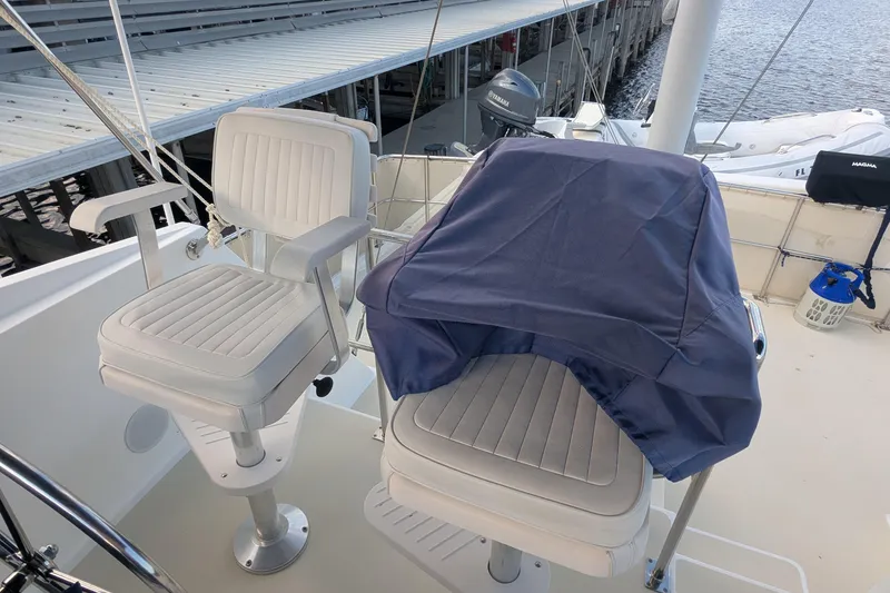 Slide: The Image of 2005 Kadey-Krogen Pilothouse boat helm with covered controls and dual captain chairs. - 50