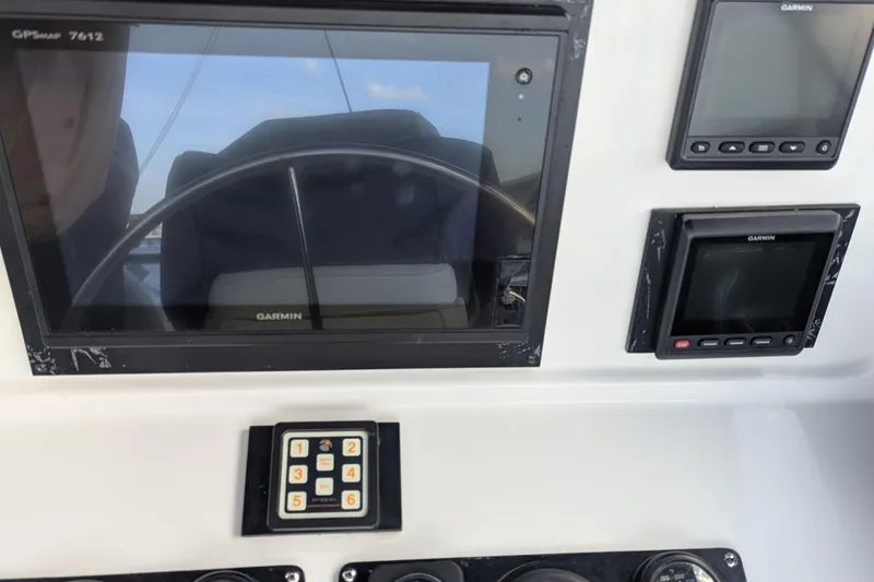 Slide: The Image of 2005 Kadey-Krogen Pilothouse helm with Garmin navigation displays and control panel. - 54
