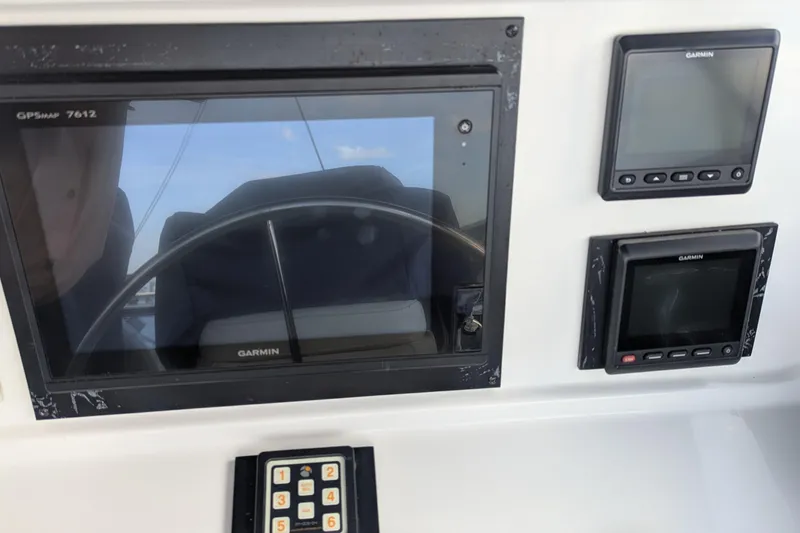 Slide: The Image of 2005 Kadey-Krogen Pilothouse dashboard with Garmin navigation displays and controls. - 55