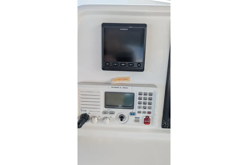 Slide: The Image of 2005 Kadey-Krogen Pilothouse navigation equipment with Garmin display and Icom VHF marine radio. - 56