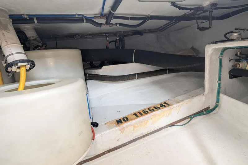 Slide: The Image of 2005 Kadey-Krogen Pilothouse engine room with pipes, tanks, and equipment. - 63