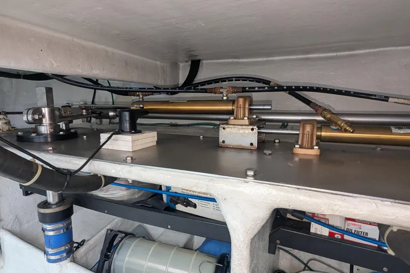 Slide: The Image of Engine room of 2005 Kadey-Krogen Pilothouse, showcasing mechanical components and piping. - 67