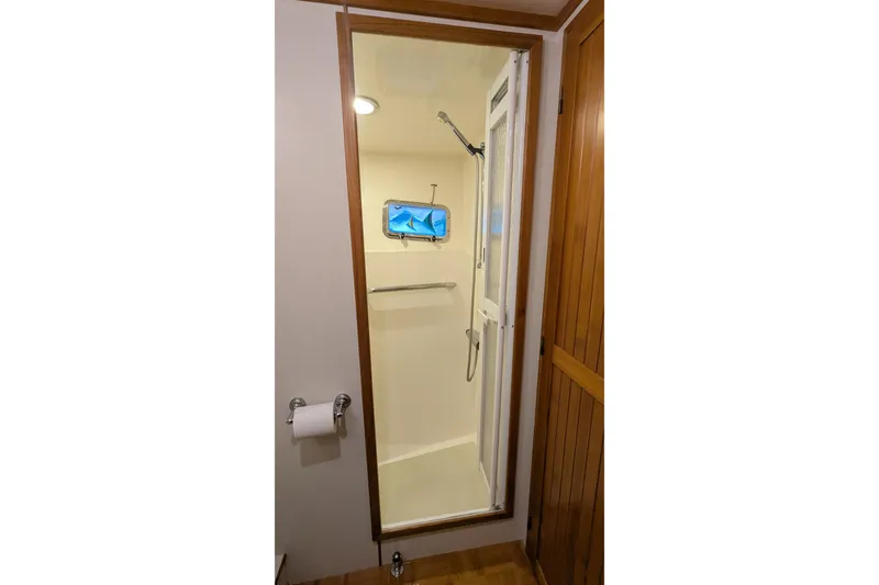 Slide: The Image of Shower area in 2005 Kadey-Krogen Pilothouse yacht with wooden door and towel rack. - 74