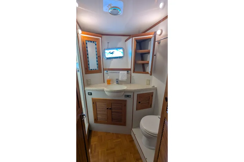 Slide: The Image of 2005 Kadey-Krogen Pilothouse bathroom with wooden cabinetry and modern fixtures. - 78