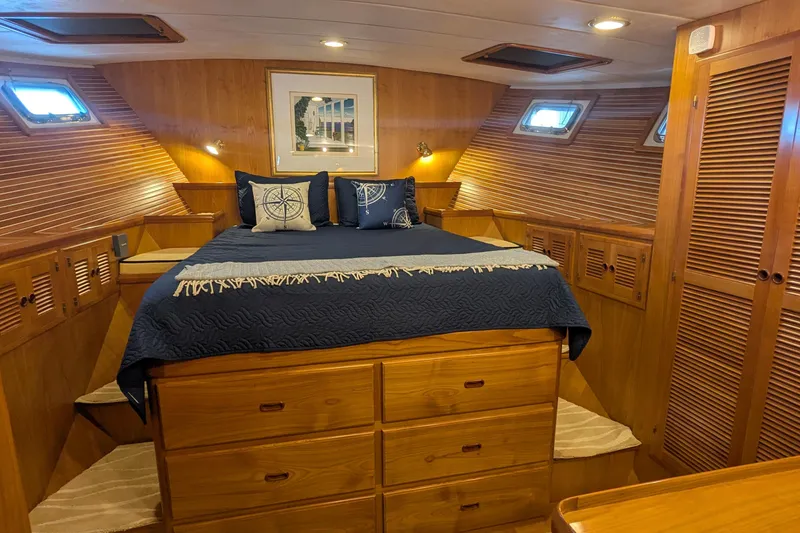 Slide: The Image of Luxurious 2005 Kadey-Krogen Pilothouse cabin with wood paneling and cozy bedding. - 79