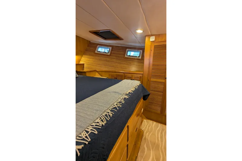 Slide: The Image of Cozy 2005 Kadey-Krogen Pilothouse cabin interior with wood paneling and bed. - 81