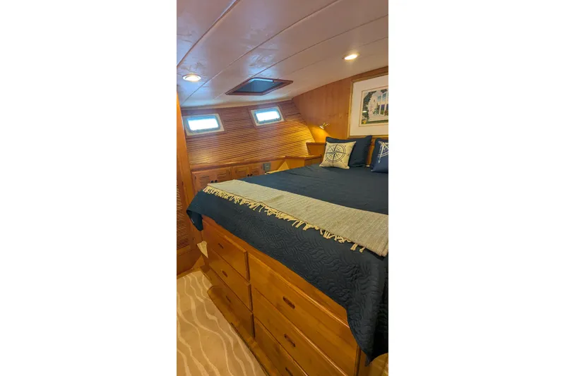 Slide: The Image of Luxurious 2005 Kadey-Krogen Pilothouse bedroom with wood paneling and nautical decor. - 82