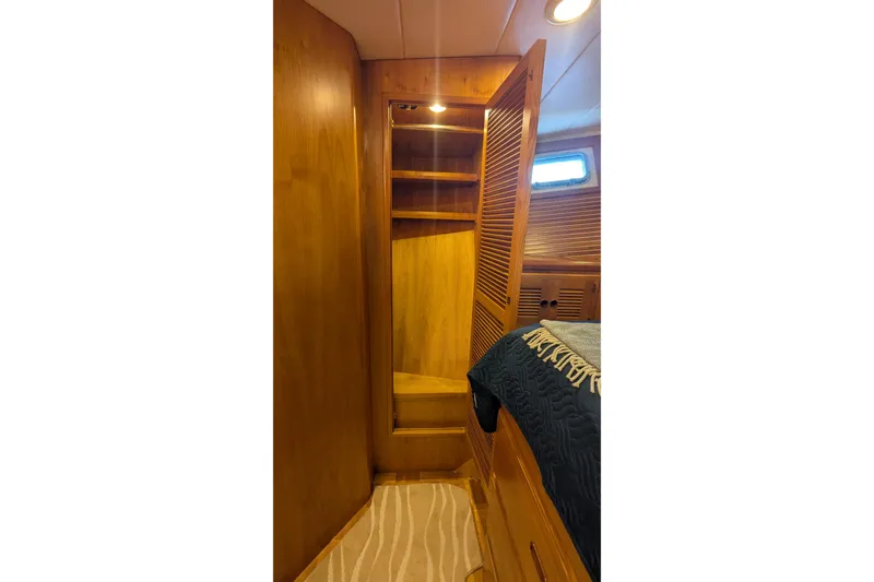 Slide: The Image of 2005 Kadey-Krogen Pilothouse interior with wooden closet and cozy cabin bed. - 83