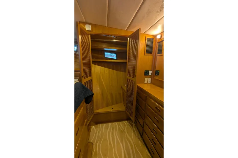 Slide: The Image of 2005 Kadey-Krogen Pilothouse interior with wooden cabinetry and open closet. - 84