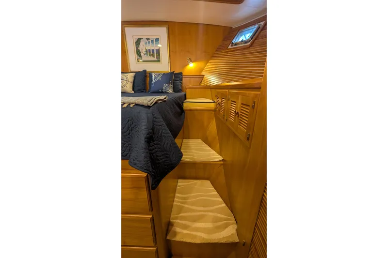 Slide: The Image of Luxurious 2005 Kadey-Krogen Pilothouse interior with cozy bed and wooden steps. - 85