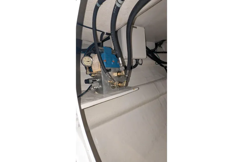 Slide: The Image of Engine room of 2005 Kadey-Krogen Pilothouse with mechanical components and hoses. - 89