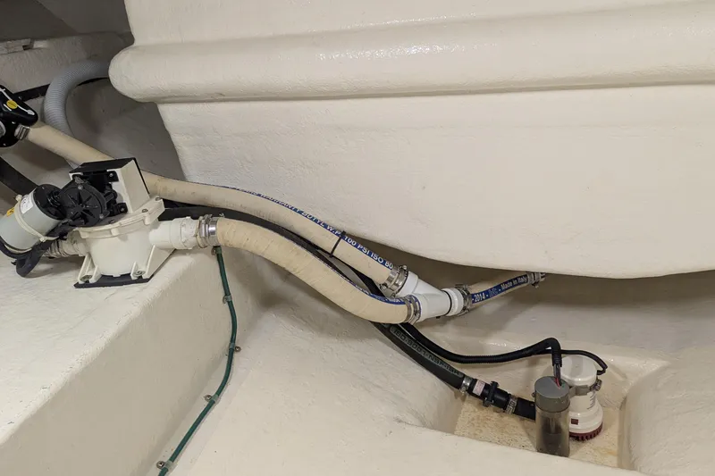 Slide: The Image of Engine room of 2005 Kadey-Krogen Pilothouse with visible plumbing and pump system. - 92