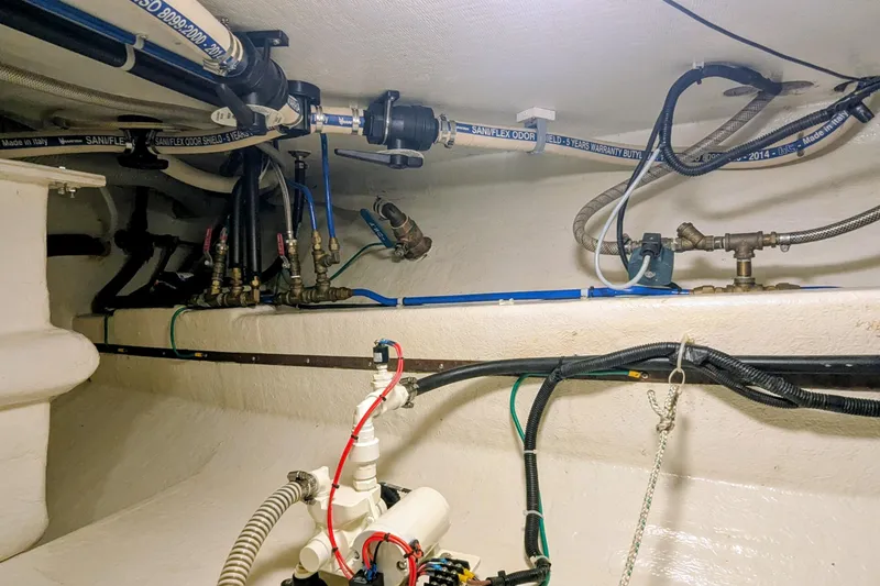 Slide: The Image of Engine room of 2005 Kadey-Krogen Pilothouse with visible plumbing and wiring systems. - 93