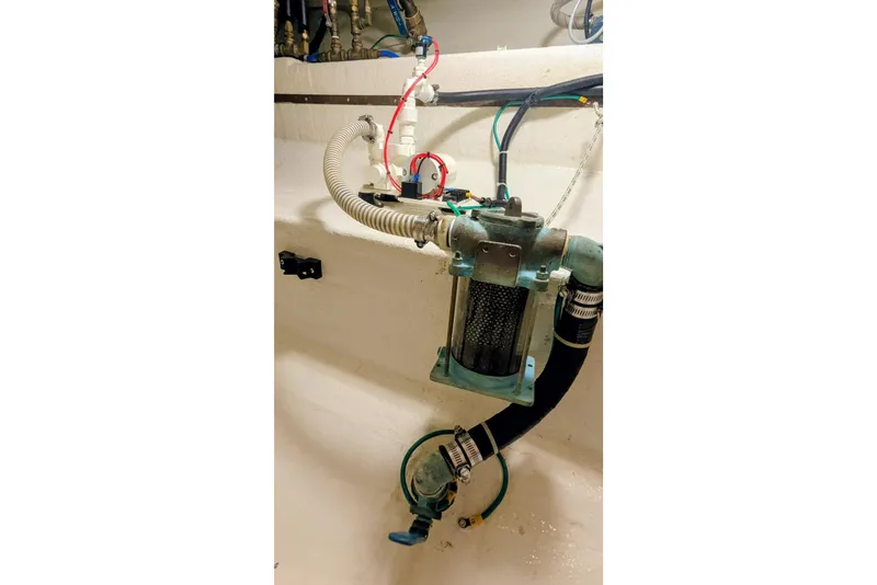 Slide: The Image of Engine room of 2005 Kadey-Krogen Pilothouse with visible plumbing and filtration system. - 94