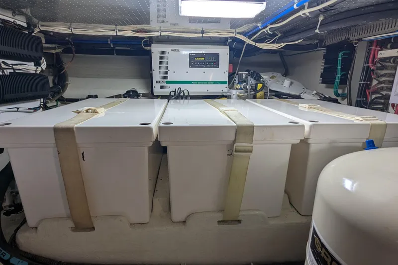 Slide: The Image of Engine room of 2005 Kadey-Krogen Pilothouse with secured storage containers and electrical equipment. - 96