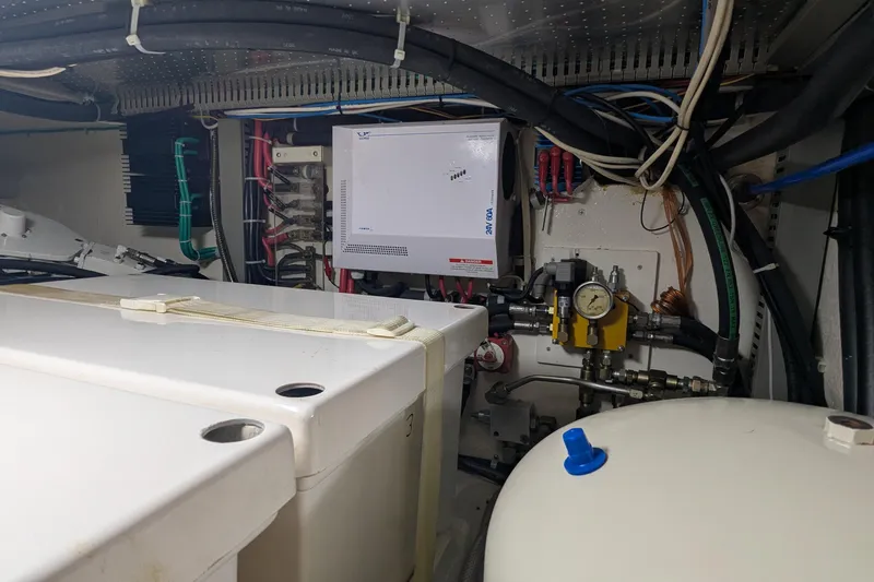 Slide: The Image of Engine room of 2005 Kadey-Krogen Pilothouse with electrical and mechanical components. - 97