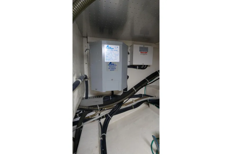 Slide: The Image of Electrical panel in 2005 Kadey-Krogen Pilothouse, featuring wiring and control boxes. - 99
