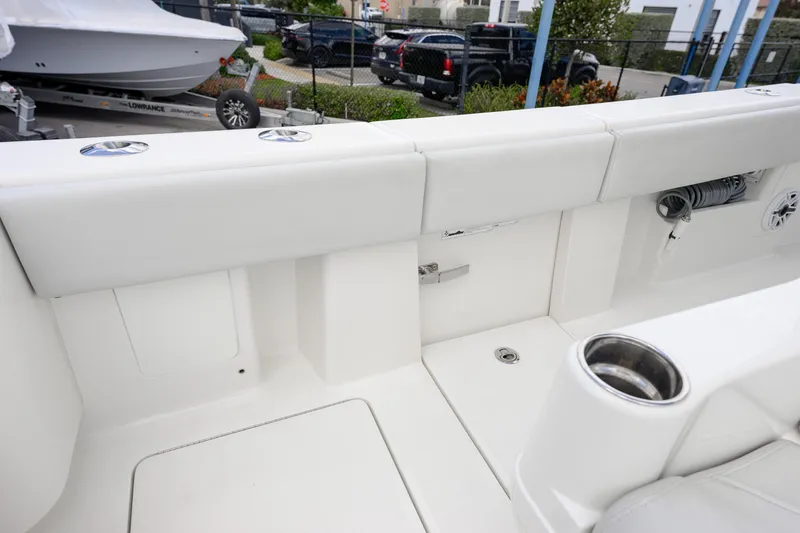 Slide: The Image of 2021 SeaVee 322Z boat interior with white seating and cup holder. - 12