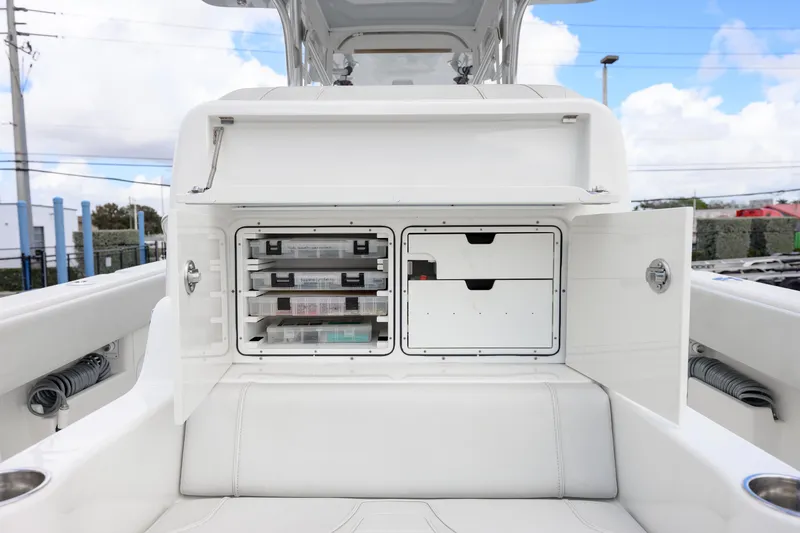 Slide: The Image of 2021 SeaVee 322Z boat storage compartments with organized tackle boxes and drawers. - 13