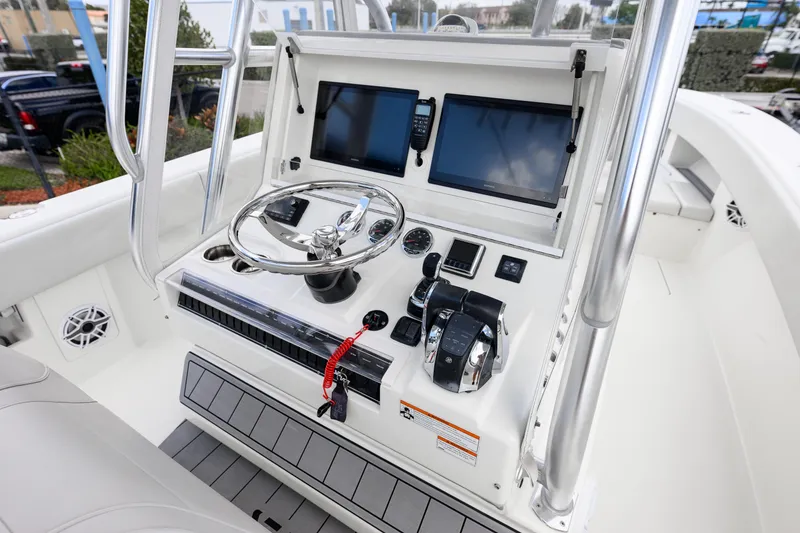Slide: The Image of 2021 SeaVee 322Z boat console with dual screens, steering wheel, and controls. - 14