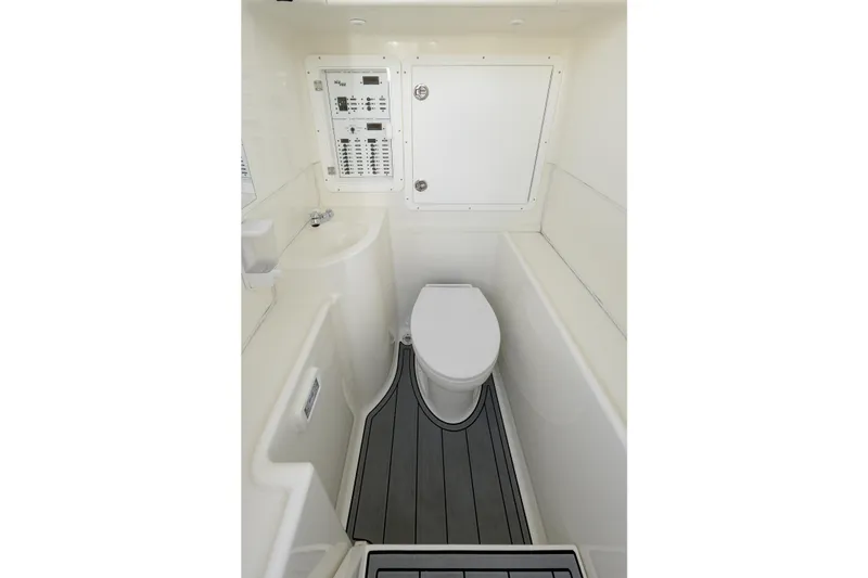 Slide: The Image of 2021 SeaVee 322Z boat interior with compact bathroom and control panel. - 19