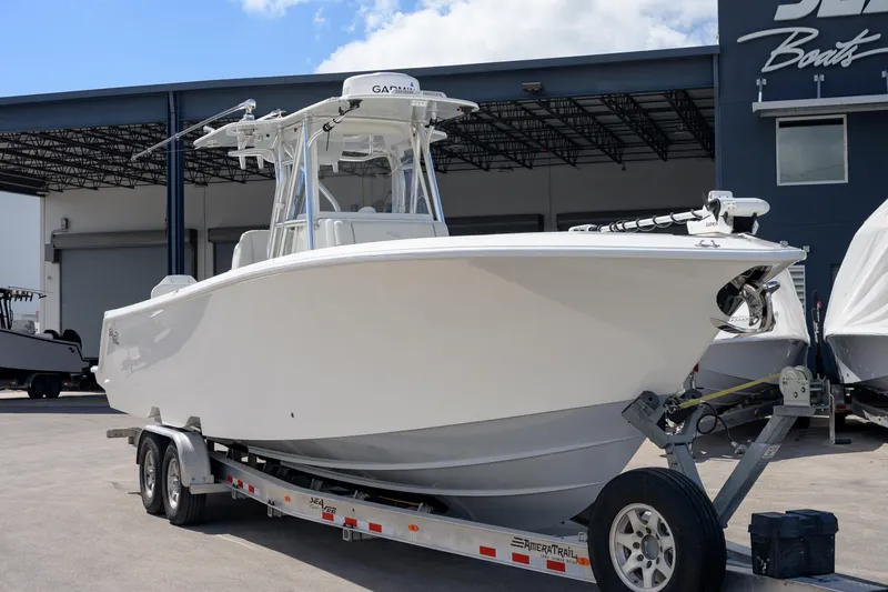 Slide: The Image of 2021 SeaVee 322Z boat on trailer at dealership, showcasing sleek design and modern features. - 3