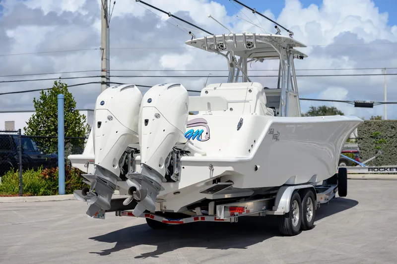 Slide: The Image of 2021 SeaVee 322Z boat on trailer with dual outboard engines, parked outdoors. - 5