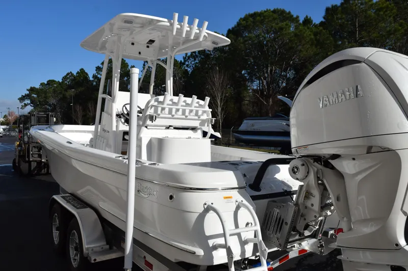 Slide: The Image of 2026 BlackJack 256 Coastal boat with Yamaha engine on trailer, parked outdoors. - 6
