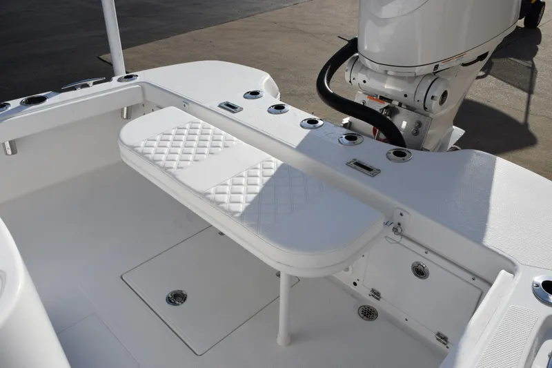 Slide: The Image of 2026 BlackJack 256 Coastal boat interior with white seating and motor. - 7