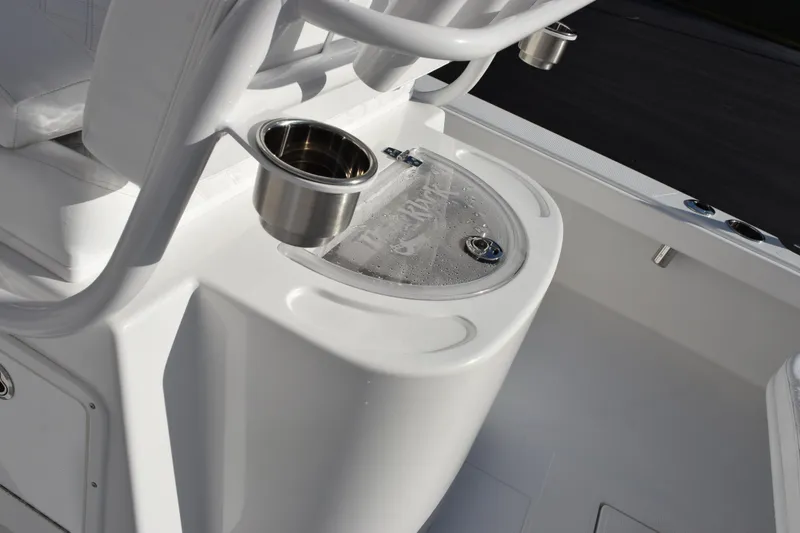 Slide: The Image of 2026 BlackJack 256 Coastal boat interior with cup holders and storage compartment. - 8