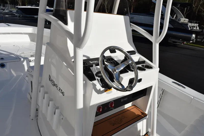 Slide: The Image of 2026 BlackJack 256 Coastal boat console with steering wheel and controls. - 9