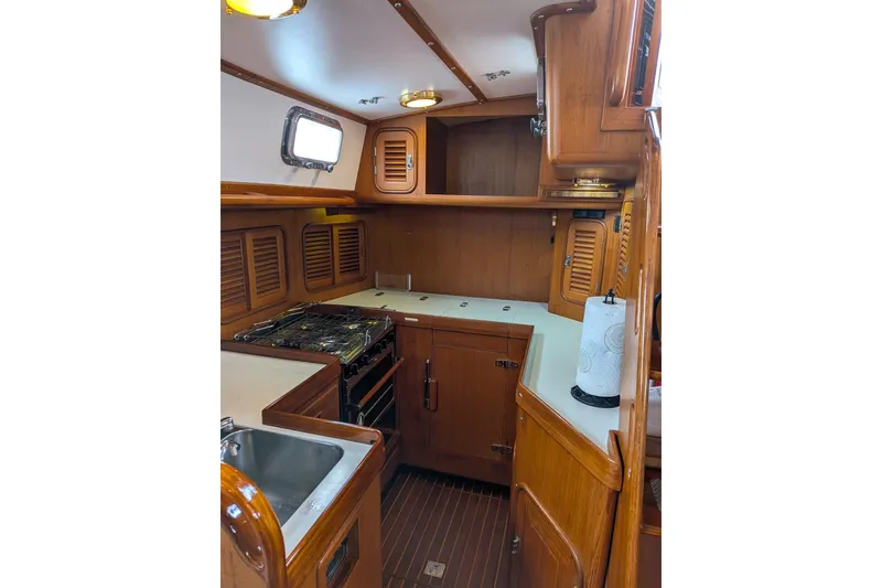 Slide: The Image of Interior of 1994 Passport Royal Passport 44 yacht with wooden finishes and seating. - 10