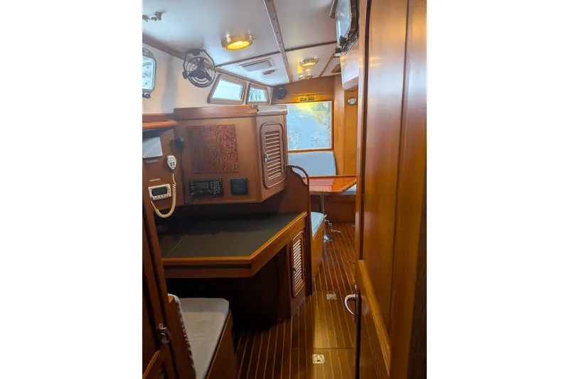 Slide: The Image of Luxurious 1994 Passport Royal Passport 44 yacht interior with wood finish and seating area. - 12