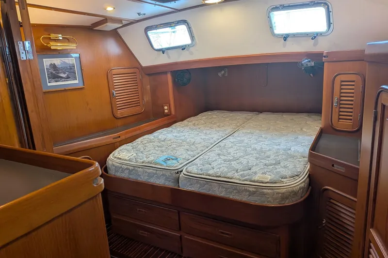 Slide: The Image of 1994 Passport Royal Passport 44 yacht kitchen with wooden cabinetry and modern appliances. - 14